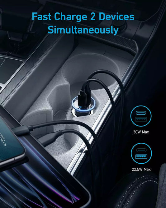 Anker 52.5W car charger fast charging two devices simultaneously inside car.